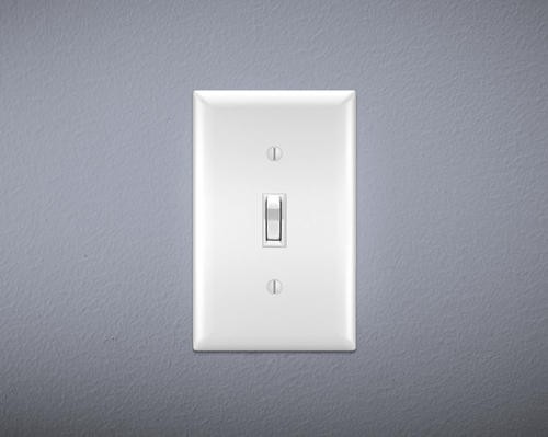 Light switch on gray wall. Switch is "on."