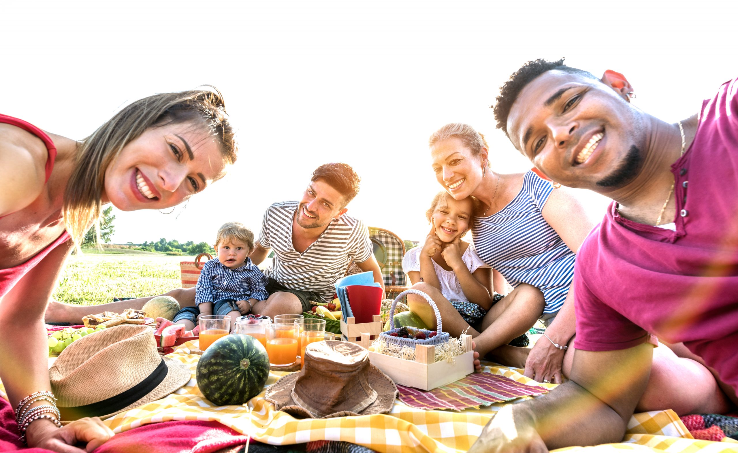 Happy-multiracial-family-taking-selfie-at-healthy-food-picnic