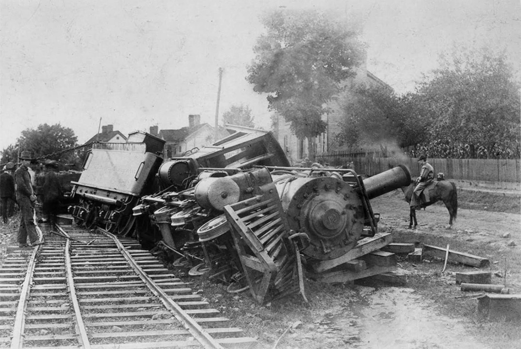 Black and White image of a derailed steam locamotive train