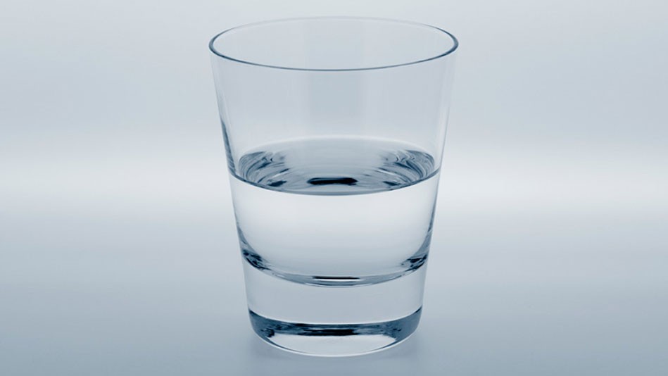 A glass of water on a white background: half full or half empty