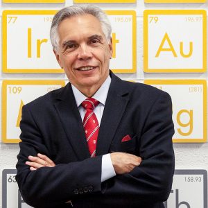 Joe Schwarcz PhD head shot in front of a periodic table