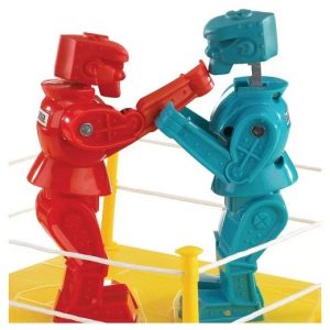 Red and blue rock 'em sock 'em robots duking it ouut in a yellow boxing ring.